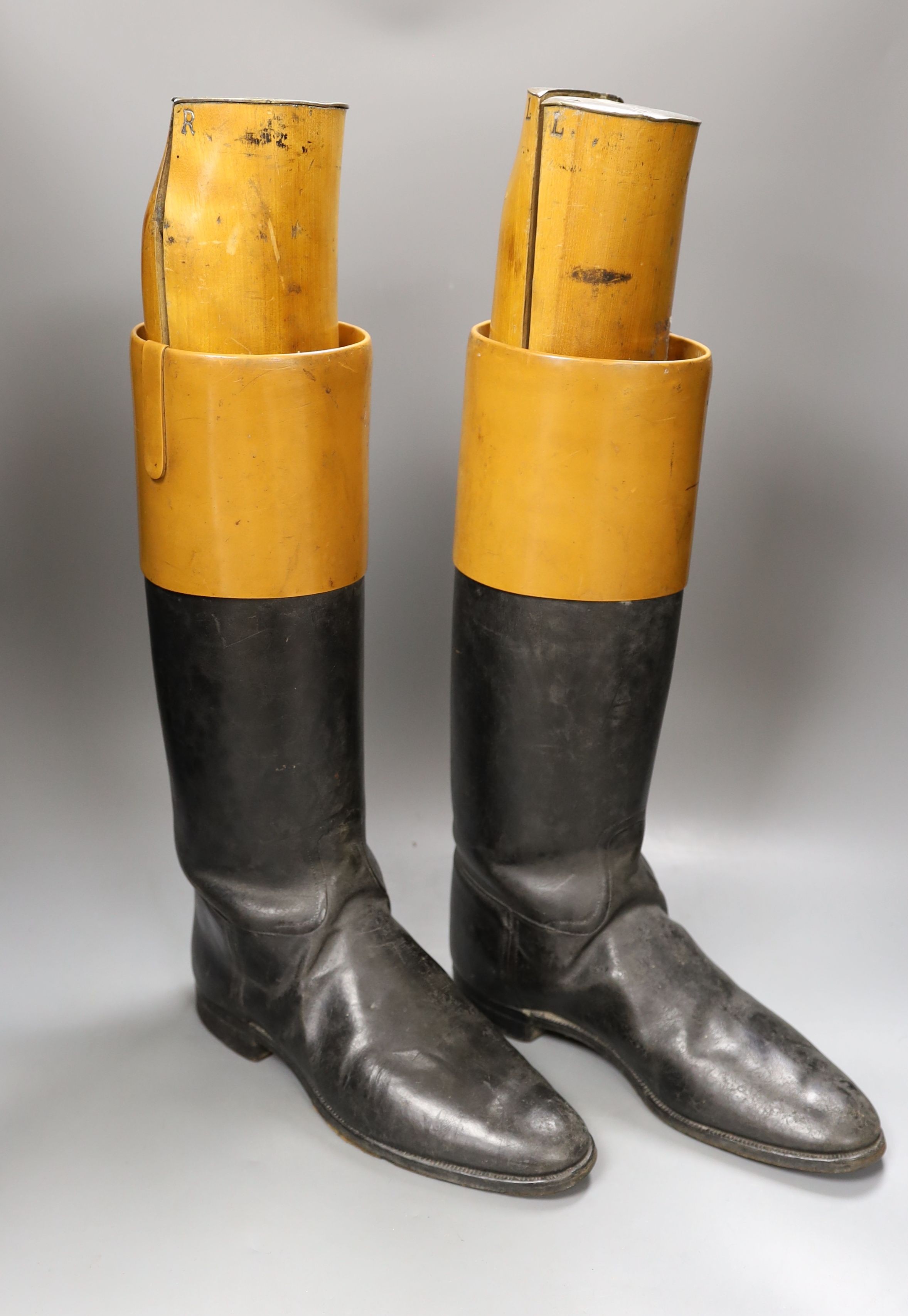 A pair of vintage leather riding boots with beech wood boot trees by Seadon Bros, St. James’s, mounted with engraved brass plates. height of trees 52 cms. *This lot is being sold in aid of the charity Prostate Cancer UK